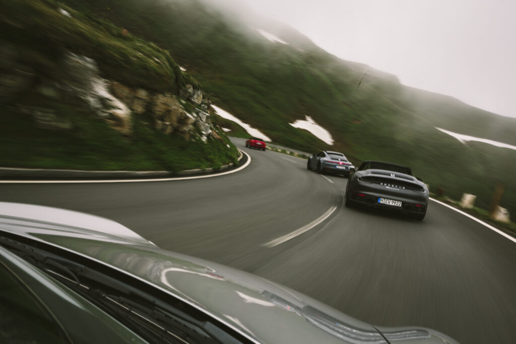 Porsches driving along the Grossglockner in the Alps of Austria.